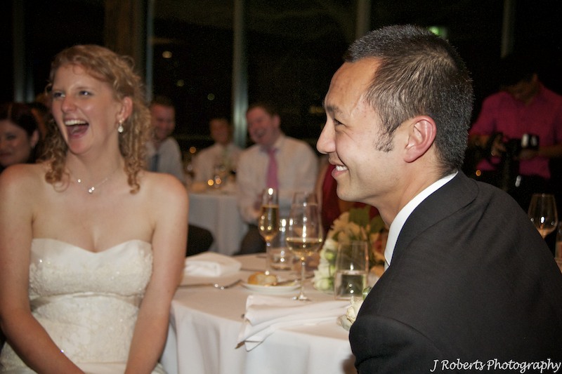 Bridal couple laughing during speeches - wedding photography sydney